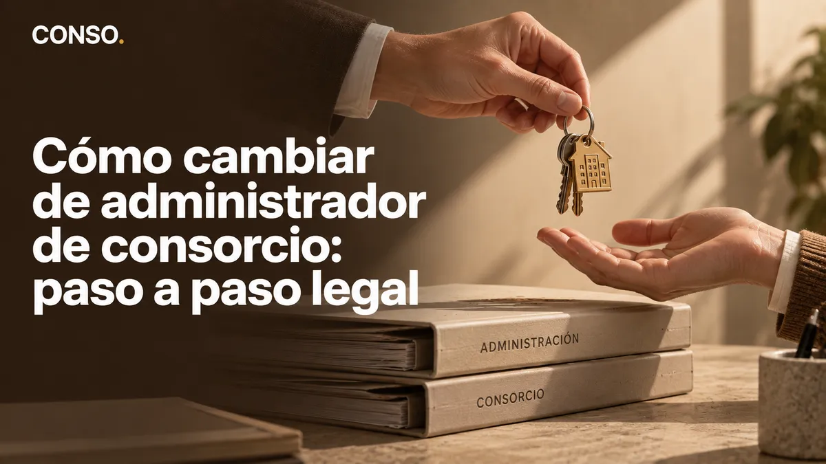 Cómo cambiar de administrador de consorcio: paso a paso legal — una mano entrega el llavero del edificio a otra, sobre las carpetas de la administración.